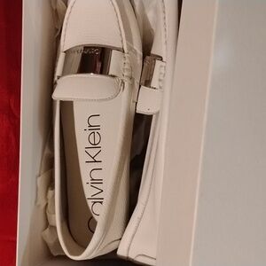 Calvin Klein comfy slip on shoes. White in color. Size 10